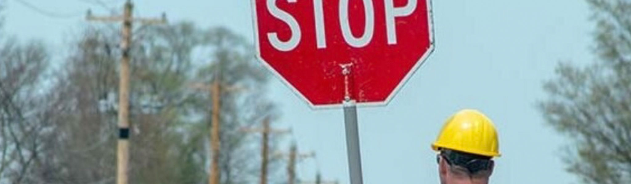Man Holding Stop Sign